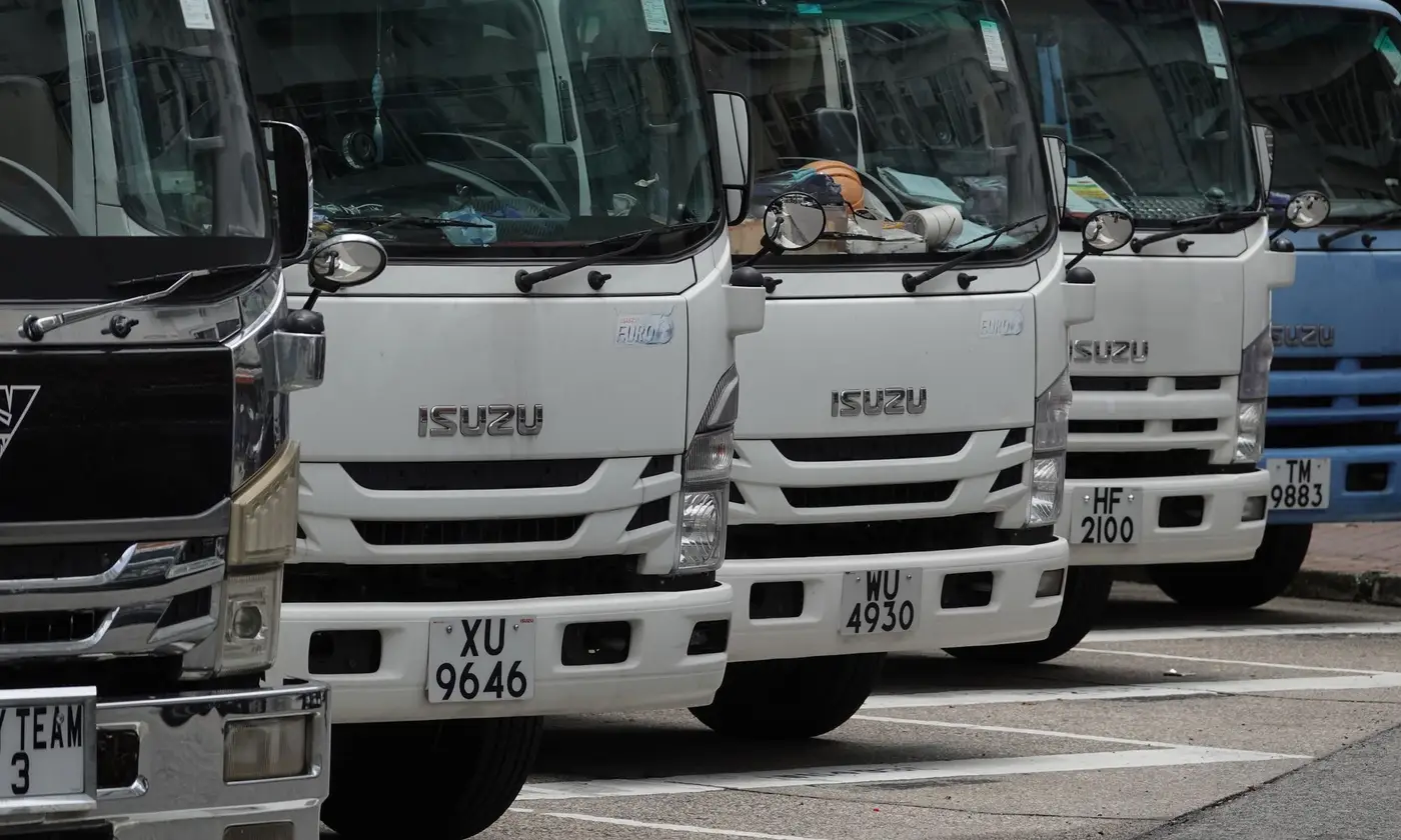Box trucks lined up nose to tail, ready to go out on hire