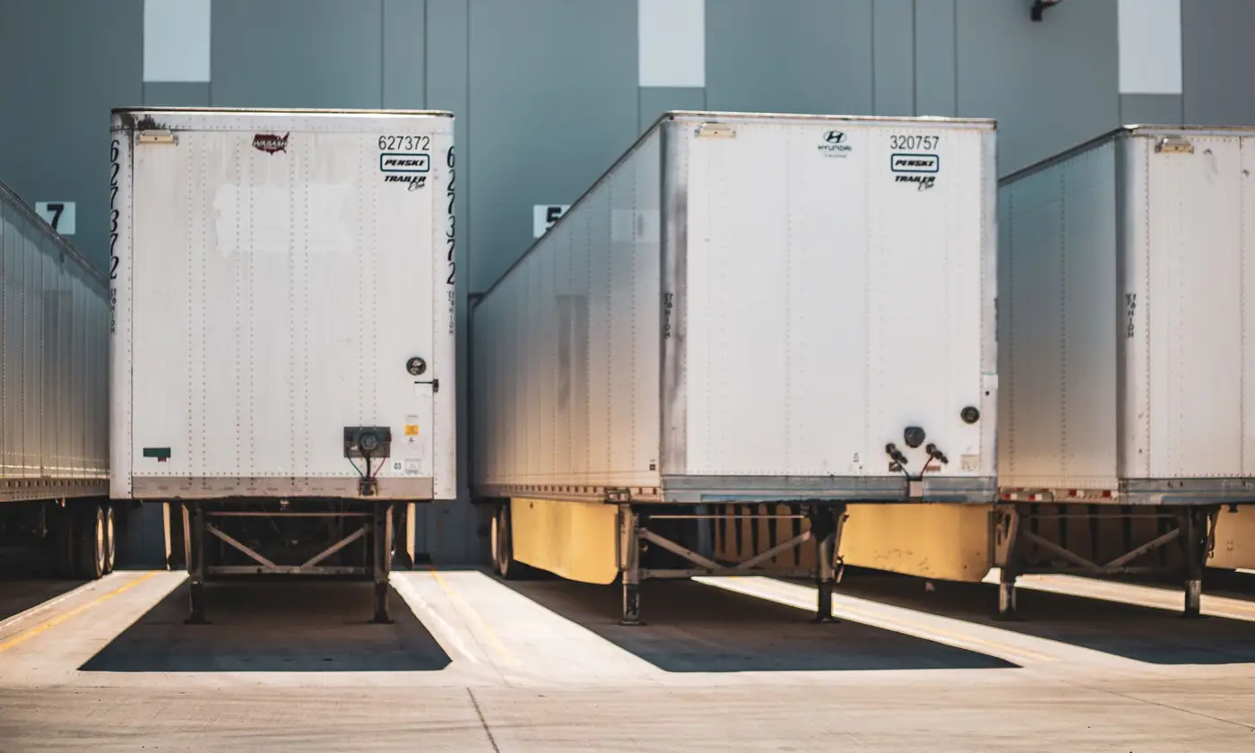 Freight trailers backed onto a warehouse loading dock